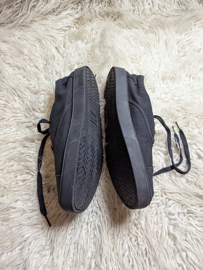 black canvas TOMS Cordones Cupsole lace-up casual sneakers.