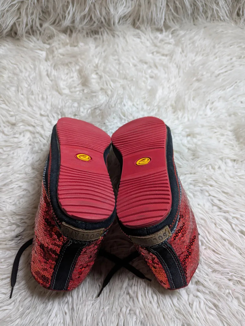 red sequin high-top sneakers with black trim and red rubber soles